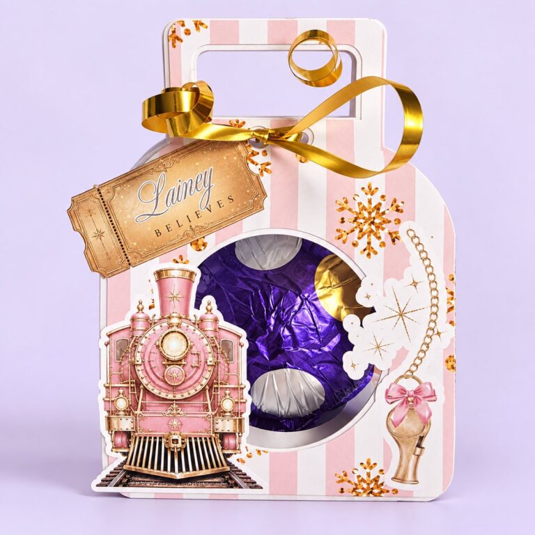 Personalised chocolate orb gift box with a pink Christmas train and a golden Believe ticket with the name Lainey